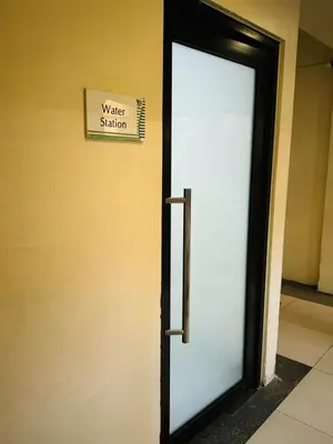 a door to a water station sign on a wall at Mid-rise staycation in parañaque in Manila