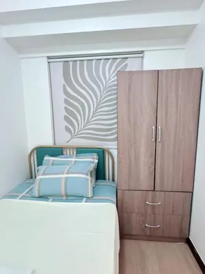 a small bedroom with a bed and a cabinet at Place to stay in pasay near Airport in Manila