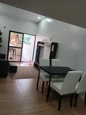 a living room with a dining room table and chairs at Stayover Transient House in Carmen
