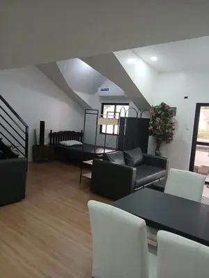 a living room with a couch and a table and chairs at Stayover Transient House in Carmen