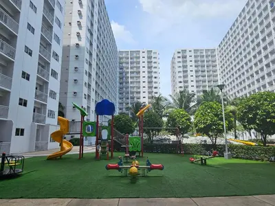 a playground in a city with buildings in the background at Shore Residences Sm Mall of Asia Caitlin in Manila