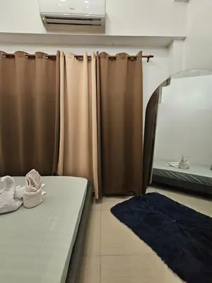 a bedroom with a bed and a mirror and a mirror at Shore Residences Sm Mall of Asia Caitlin in Manila