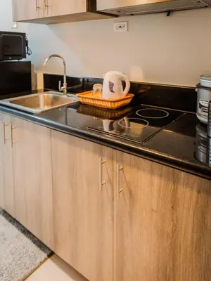 a kitchen with a sink and a counter top at The Bat Cave 3 at Coast Residences Pasay in Manila