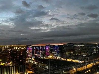 a view of a city at night with illuminated buildings at Modern Boutique Spacious Apartment Near Airport OKADA SOLAIRE MOA in Manila