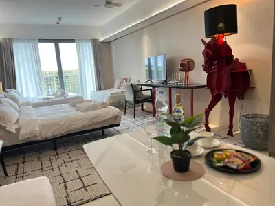 a living room with a bed and a dining room at Modern Boutique Spacious Apartment Near Airport OKADA SOLAIRE MOA in Manila