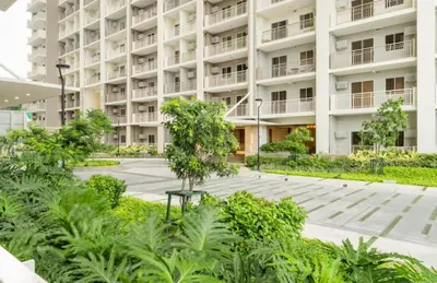 an apartment building with a garden in front of it at Prisma Residences by Kozy Mood near BGC in Manila