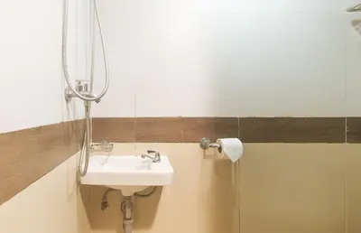 a bathroom with a sink and a mirror at RedDoorz Premium at MyTown New York in Manila