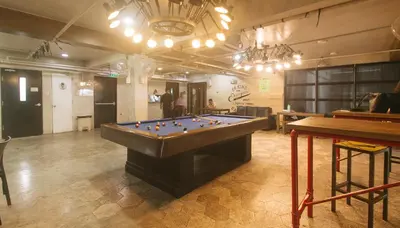 a large room with a pool table in it at RedDoorz Premium at MyTown New York in Manila