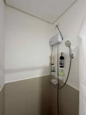 a shower in a bathroom with a shower head at HOPE RESIDENCES UNIT 606 building D in Trece Martires
