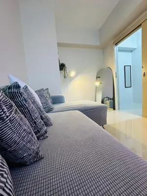 a bedroom with two beds with pillows and a mirror at 6G Manor in Manila