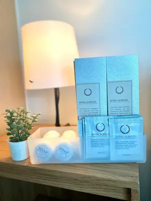 three boxes of soap sitting on a table at Uptown Parksuites Posh Modern Minimalist in Manila