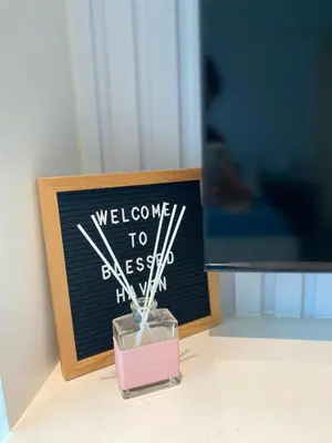a blackboard with a pink box with a toothbrush in it at Uptown Parksuites Posh Modern Minimalist in Manila