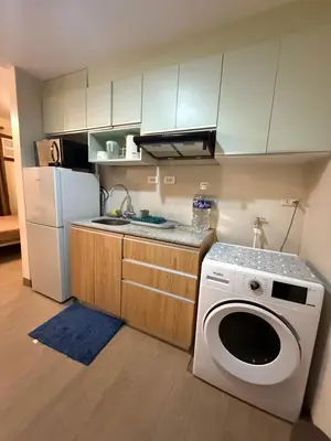 a kitchen with a washing machine and a refrigerator at The Cozy Rustic in General Trias