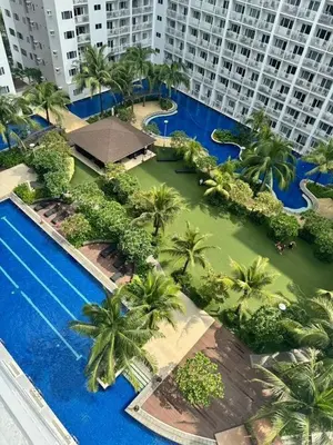 an aerial view of a resort with palm trees and a swimming pool at Shore Residences 2 Beds Forest Green RM 630 by Prime Stay in Manila