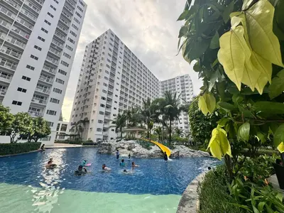 a group of people in a swimming pool with buildings at Shore Residences 2 Beds Forest Green RM 630 by Prime Stay in Manila