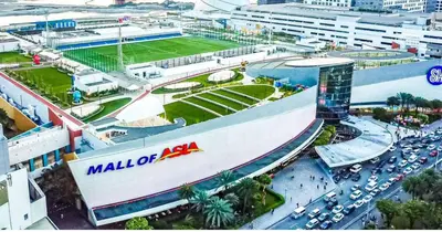 a large building with a mall ofza sign in a city at Shore Residences 2 Beds Forest Green RM 630 by Prime Stay in Manila