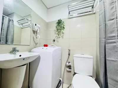 a white bathroom with a toilet and a sink at Shore Residences 2 Beds Forest Green RM 630 by Prime Stay in Manila