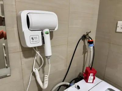 a bathroom with a blow dryer on a wall at Shore Residences 2 Beds Forest Green RM 630 by Prime Stay in Manila