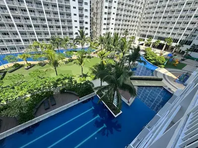 an overhead view of a swimming pool with palm trees and buildings at Shore Residences 2 Beds Forest Green RM 630 by Prime Stay in Manila