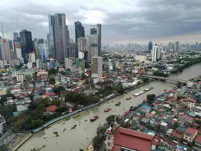 a view of a city with a river and buildings at RBR LUX at Novotel Manila Hotel Residences Acqua in Manila