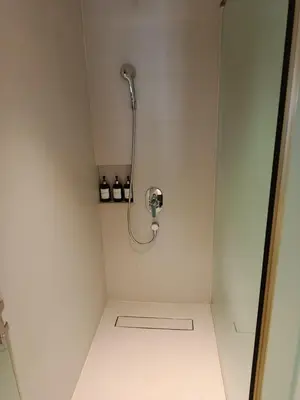 a small shower in a bathroom with a hose at RBR LUX at Novotel Manila Hotel Residences Acqua in Manila