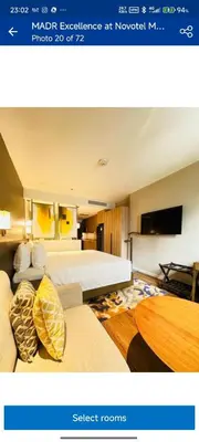 a hotel room with two beds and a flat screen tv at RBR LUX at Novotel Manila Hotel Residences Acqua in Manila