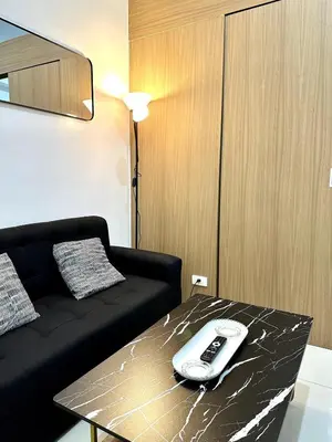 a remote control sitting on top of a table at City SkyView - Level 24 - Pool - Lush Residences in Manila