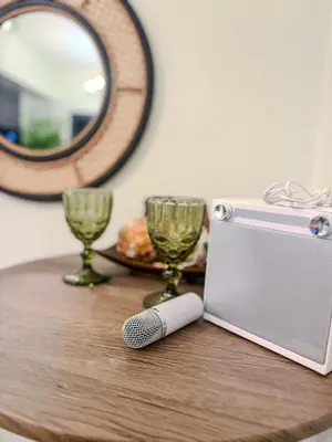 a table with a camera and two glasses and a mirror at Relax in Comfort at Shore 2 Residences Mall of Asia-Pasay in Manila