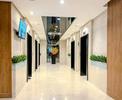 an empty hallway of a building with plants at Relax in Comfort at Shore 2 Residences Mall of Asia-Pasay in Manila