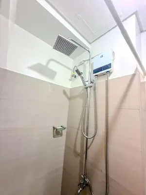 a bathroom with a shower with a laptop on the ceiling at Relax in Comfort at Shore 2 Residences Mall of Asia-Pasay in Manila
