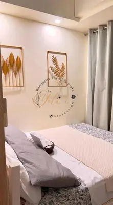 a bedroom with two beds and a picture on the wall at 1BR Unit for 2 pax Makati City in Manila
