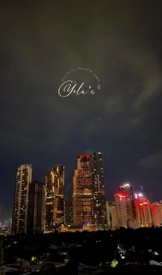 an airplane is flying over a city at night at 1BR Unit for 2 pax Makati City in Manila