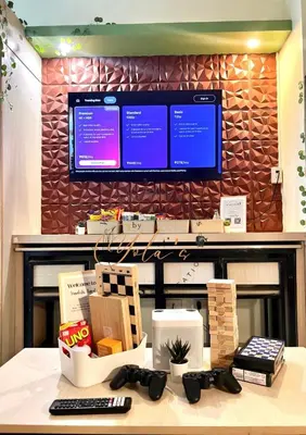 a desk with a television and a keyboard and a remote control at 1BR Unit for 2 pax Makati City in Manila