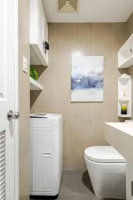 a bathroom with a toilet and a painting on the wall at Air Bel & Be! Your space, Your calm, Your comfort in Manila