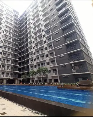 a large apartment building with a large swimming pool at StaycationPH in Manila