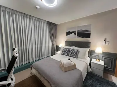 a bedroom with a large bed and a large window at 1BR - Uptown BGC Taguig in Manila