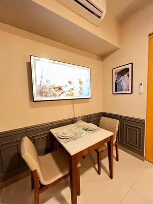 a dining room with a table and chairs at 1BR - Uptown BGC Taguig in Manila