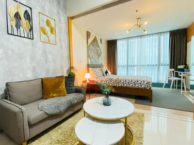 a living room with a couch and a table at 1BR - Uptown BGC Taguig in Manila