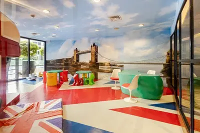a room with a mural of a bridge on the wall at Opulent Condo Knightsbridge Residences in Manila