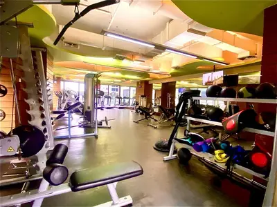 a gym with lots of equipment in a room at Opulent Condo Knightsbridge Residences in Manila