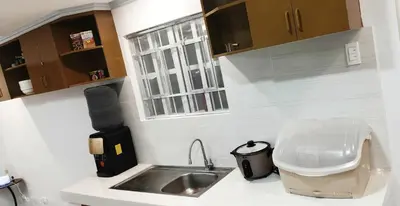 a small kitchen with a sink and a window at Thai Nee Homestay in Manila