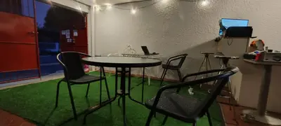 a room with a table with chairs and a laptop at Thai Nee Homestay in Manila