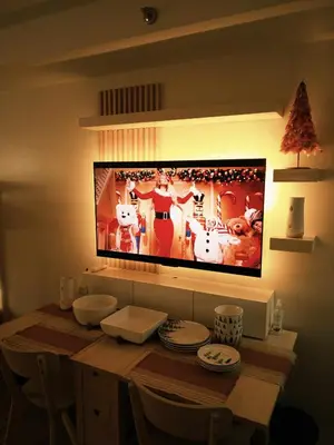 a television hanging on a wall with a christmas display at ANANDA SQUARE studio unit in Manila