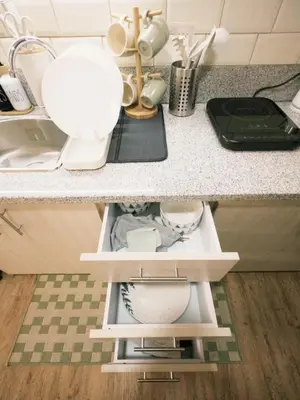 a kitchen counter with a sink and a counter top with dishes at ANANDA SQUARE studio unit in Manila