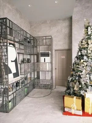 a christmas tree in a living room next to a christmas tree at ANANDA SQUARE studio unit in Manila