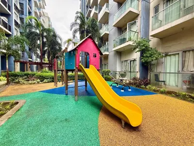 a playground with a slide and a house at Condo in Pasay Across Airport NAIA Terminal 3 Pool View in Manila