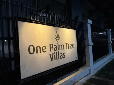 a one palm tree villas sign on a fence at Condo in Pasay Across Airport NAIA Terminal 3 Pool View in Manila