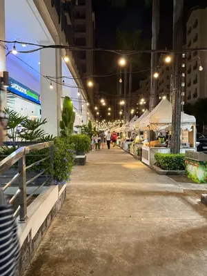 a sidewalk with people walking down it at night at Condo in Pasay Across Airport NAIA Terminal 3 Pool View in Manila