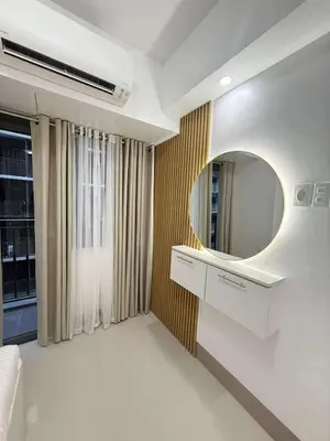 a living room with a mirror and a couch at Condo in Shore 3 Residences, Pasay in Manila