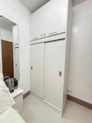 a bedroom with white walls and a large closet at Condo in Shore 3 Residences, Pasay in Manila